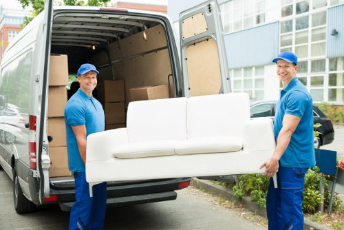 Local team removing an old sofa and chairs from a Surrey property