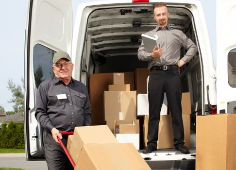 Removal team loading household furniture for a Surrey home move