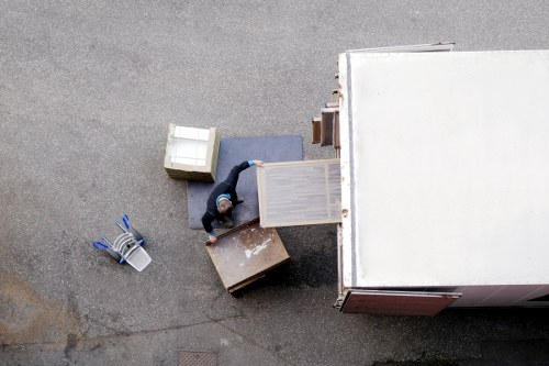 Local removals crew handling furniture in a Surrey property with narrow access