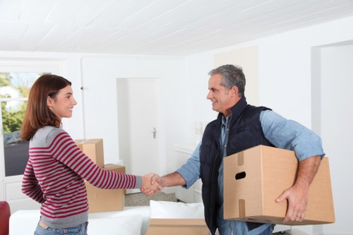 Commercial moving team organising office furniture at the new premises